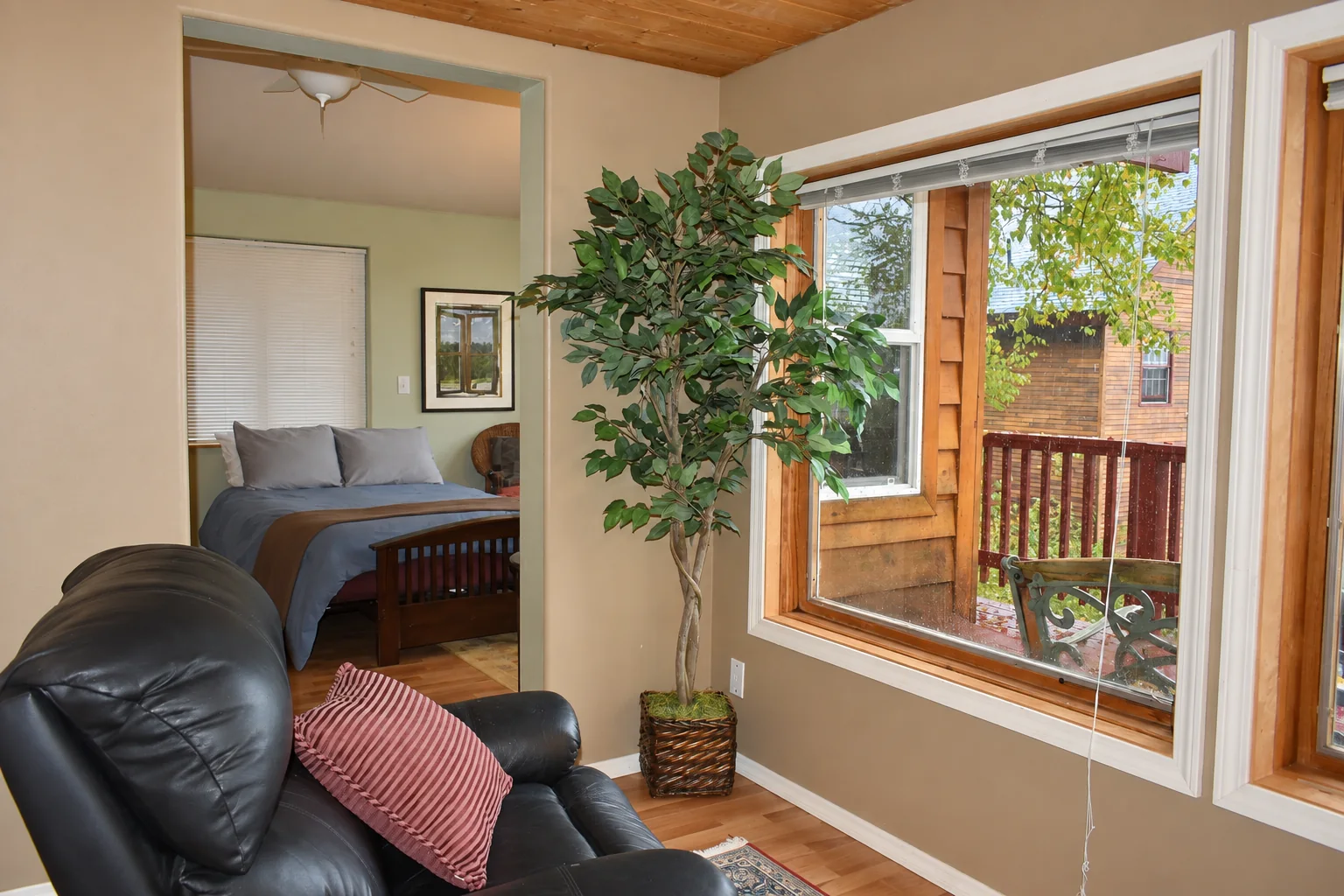 Lounge and bedroom entrance surrounded by large windows in Northern Exposure Cabin