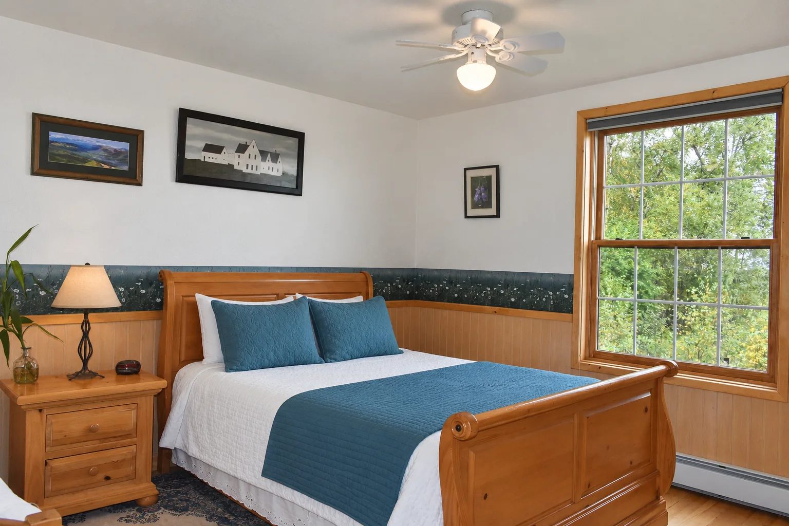 Queen bed beside the window in Summer Solstice Room