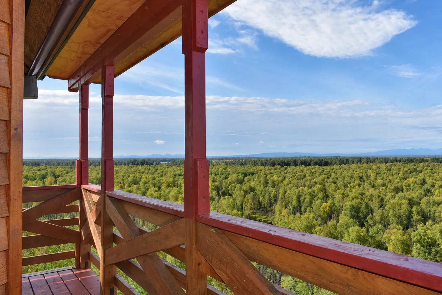 Balcony overlooking autumn forest from Denali View Suite at Denali Overlook Inn