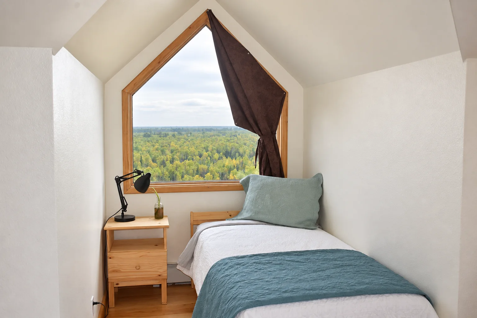 Twin bed with an Alaska Range view in Mt. Hunter Room
