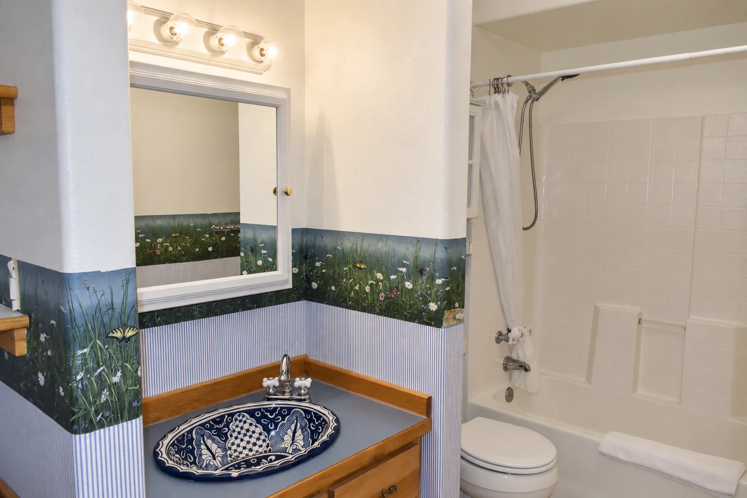 Private bathroom with bathtub and shower in Summer Solstice Room