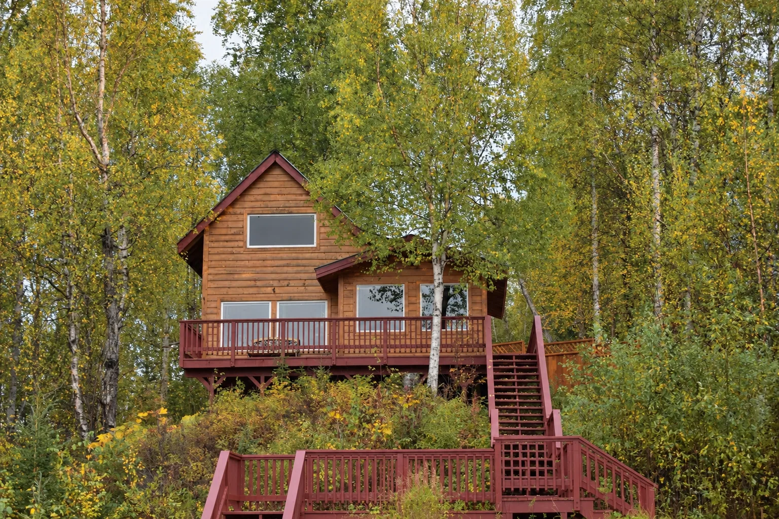 Northern Exposure Cabin surrounded by autumn trees at Denali Overlook Inn