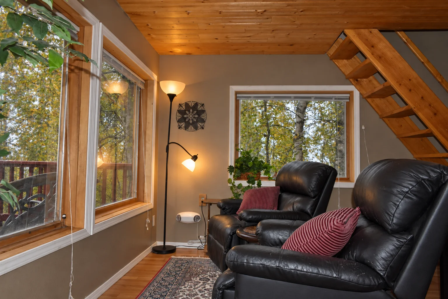 Leather seating area beside the windows in Northern Exposure Cabin