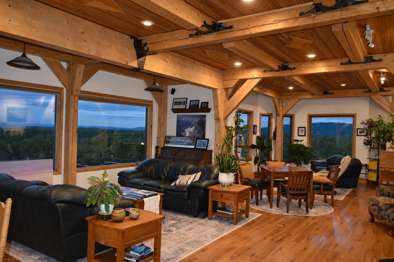 Open-plan lounge and dining area with exposed timber beams at Denali Overlook Inn