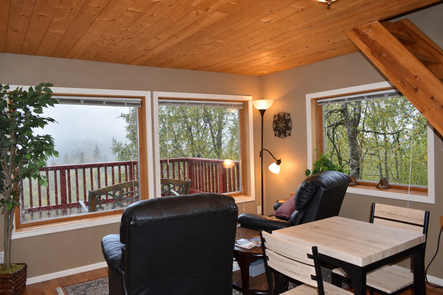 Living and dining area with large windows in Northern Exposure Cabin