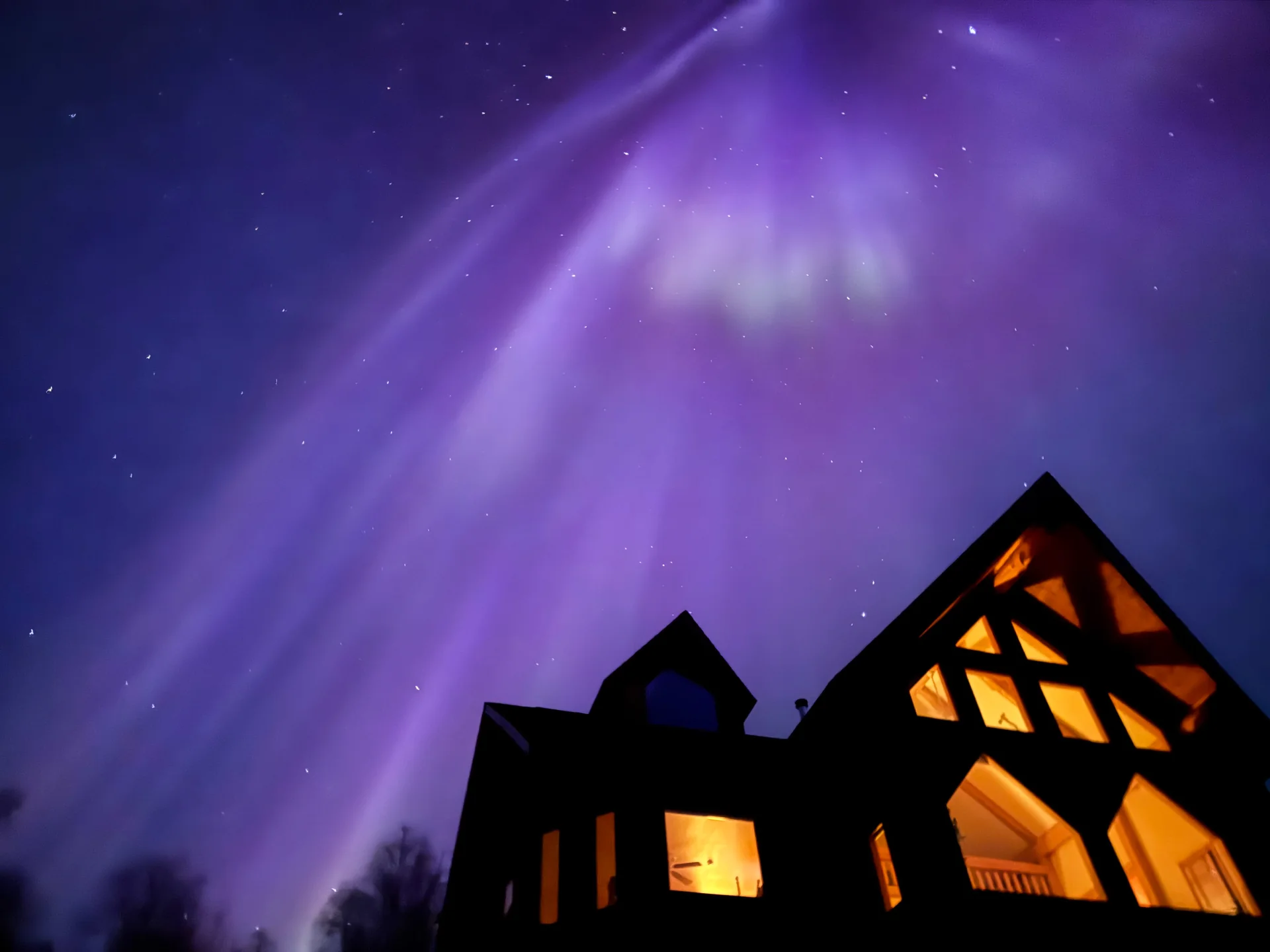 Purple northern lights and stars above Denali Overlook Inn