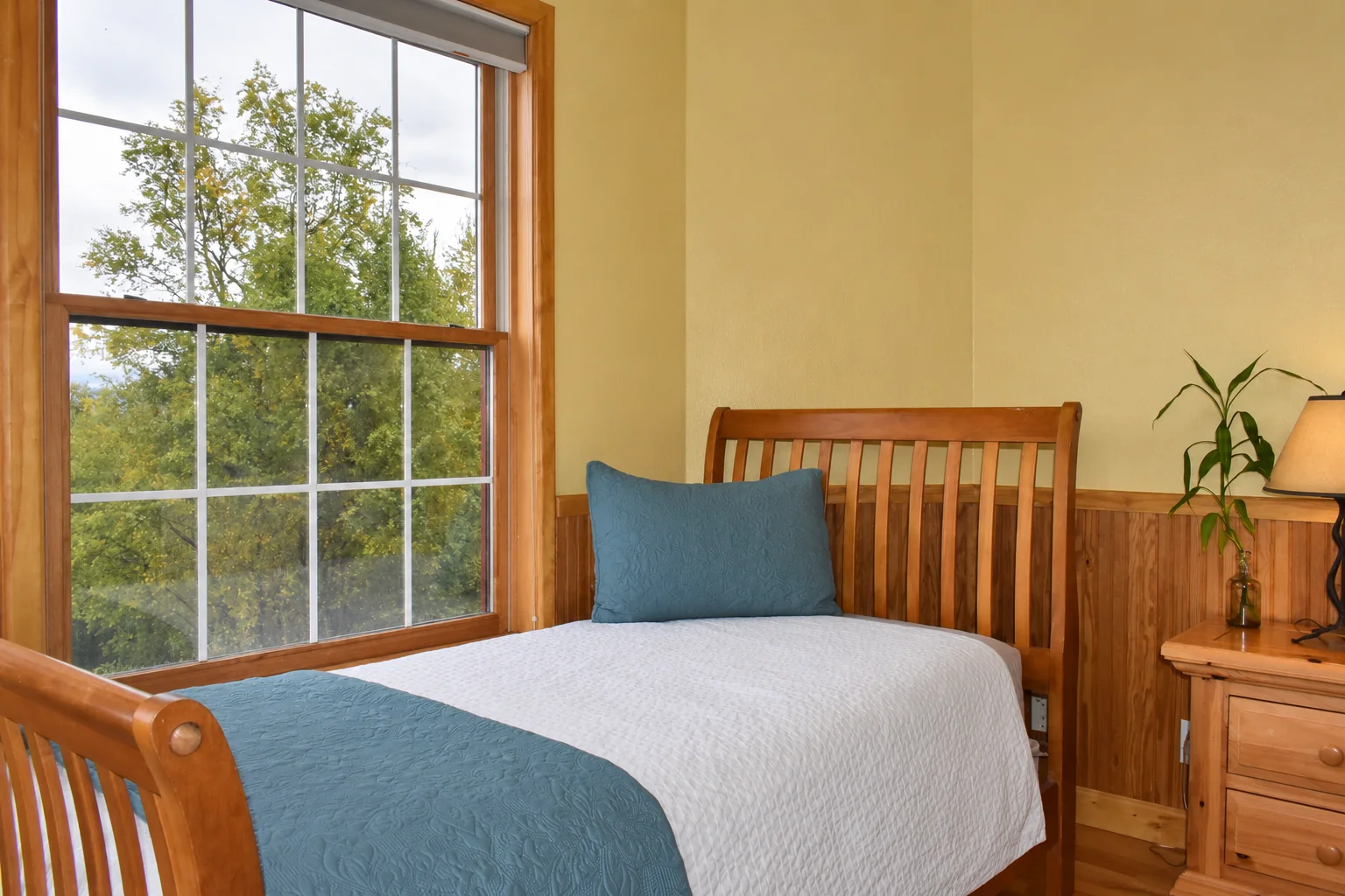Twin bed beside the window in Victorian Room