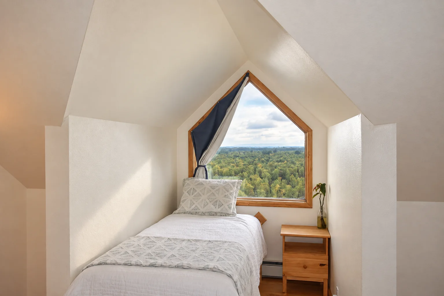 Twin bed beside the window in Mt. Foraker Room